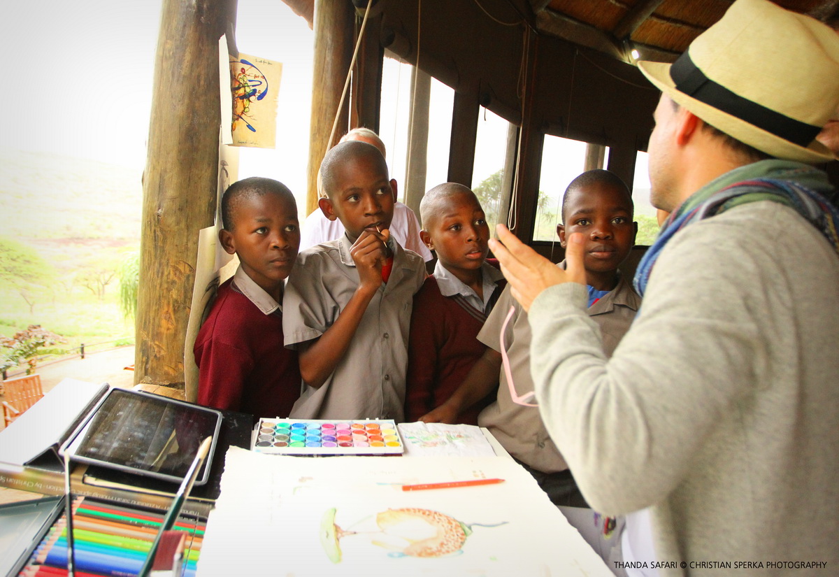 Leslie Sardinias explaining his work to four interested Star For Life school students