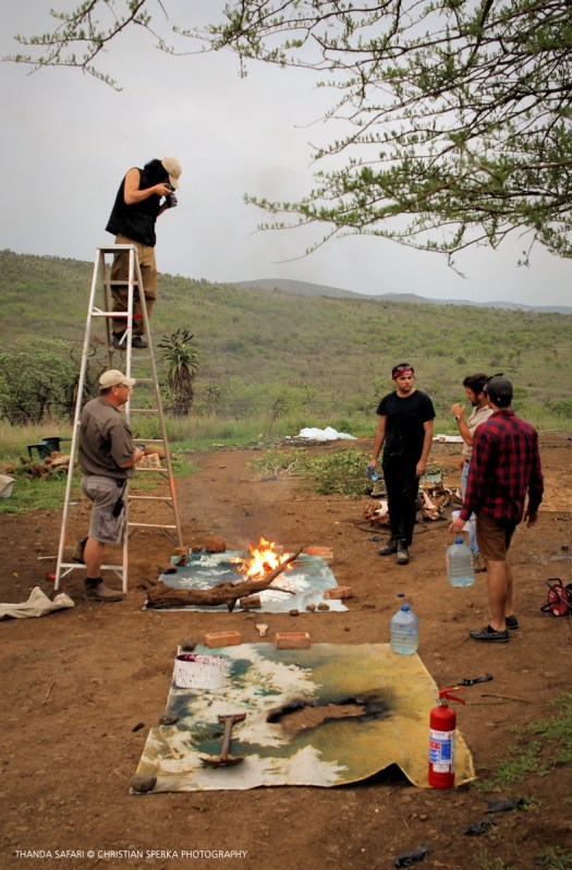Korakrit Arunanondchai taking video of a burn as part of his installation art