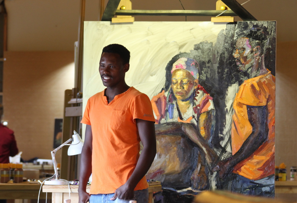 A young Zulu model in front of the group portrait which he is part of
